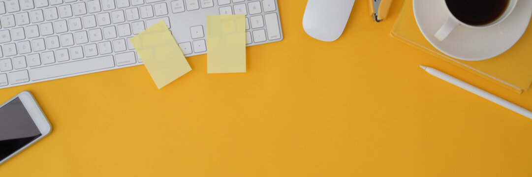 Cropped shot of computer device on yellow background