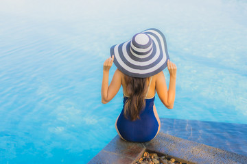 Fototapeta na wymiar Portrait beautiful young asian woman relax around swimming pool in hotel resort