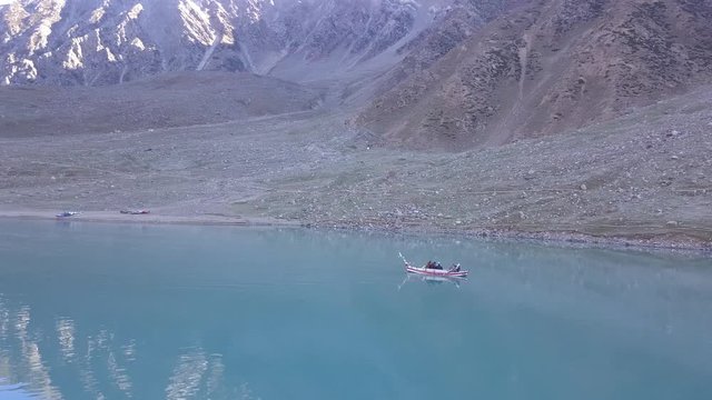 Boat paddling in lake saiful malook in naran valley of Northern Pakistan mountains in autumn season