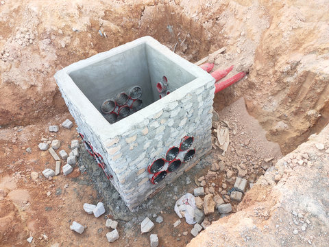Utility services manhole under construction at the construction site. In-situ construction by workers based on infrastructure engineer design.