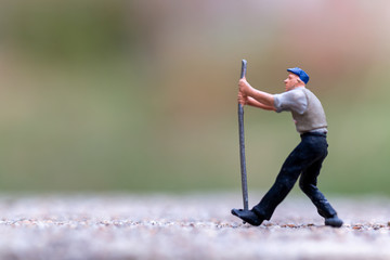 Miniature people , worker holding tools and copy space for your text , Labour day concept