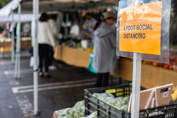 Farmers Market in Los Angeles, March 2020: signs with safety guidance urging people to keep distance and pick up only produce they want to buy, Los Angeles, California, USA