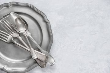 Silverware on a pewter plate