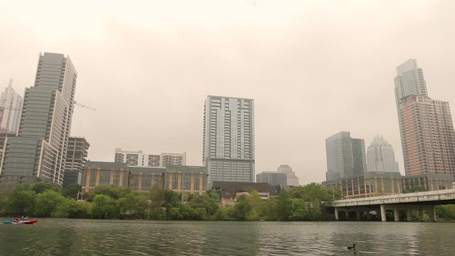 Austin Texas urban city landscape establishing shot. Colorado River in the foreground.