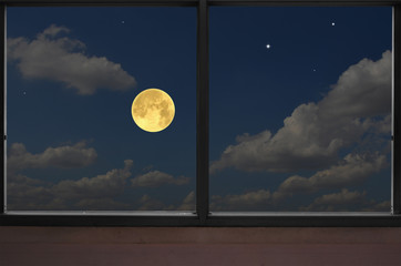 Romantic full moon in blue sky in the window view