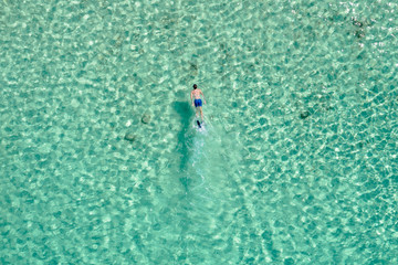 Overhead drone shot of man swimming in ocean