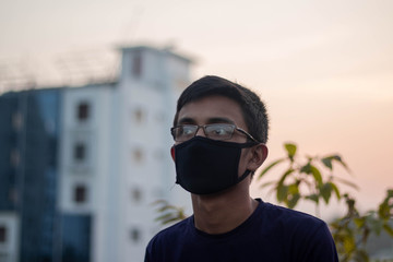 American boy wearing protection face mask against coronavirus outbreak COVID-19. Banner panorama medical staff preventive gear.People of Bangladesh wearing mask to protect themselves from covid-19