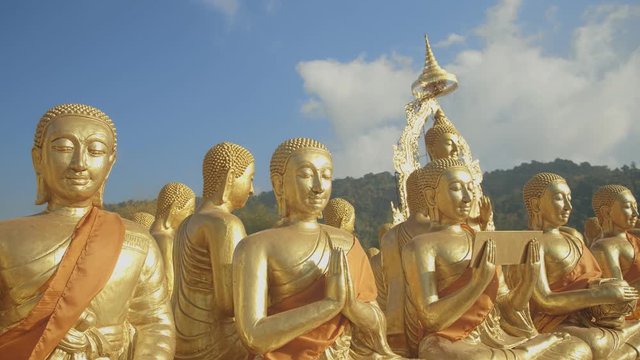golden Buddha sculpture and disciples sculpture Makha bucha buddhist memorial park is built on the occasion of great period, buddha 2600 years at Nakornnayok province..