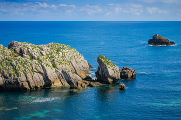 Fototapeta premium Incredible cliffs on the coast near the village of Liencres. Cantabria. Northern coast of Spain