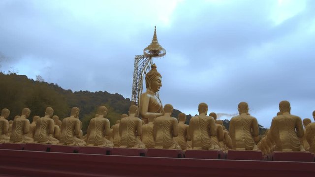 golden Buddha sculpture and disciples sculpture Makha bucha buddhist memorial park is built on the occasion of great period, buddha 2600 years at Nakornnayok province..