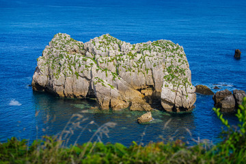 Naklejka premium Incredible cliffs on the coast near the village of Liencres. Cantabria. Northern coast of Spain