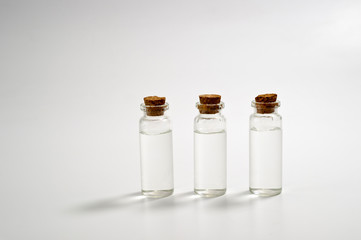 Three glass corked bottles filled with liquid. Background for science and medicine. Virus vaccine.
