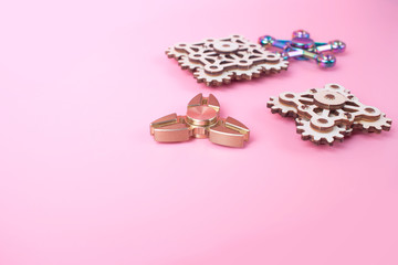 fidget finger spinners antistress, anxiety relief toy on pink background. spinners made different...