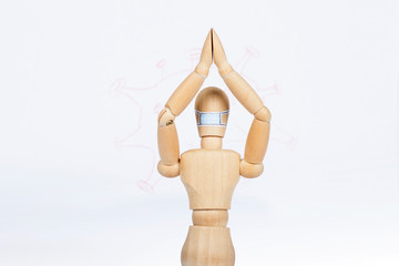 Wooden doll protects against coronovirus.