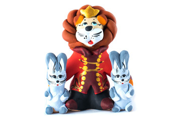 lion and hares statuette made of clay isolated on white background