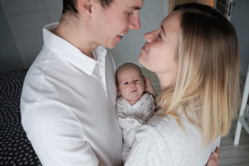 Family portrait: mother, father and newborn baby.