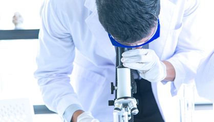 Young scientists biologists or researchers putting personal protective equipments to prevent...