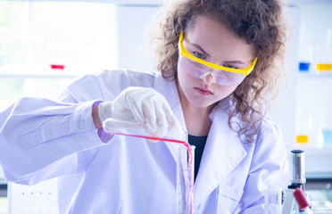 Beautiful young scientist biologists or researchers putting personal protective equipments to...
