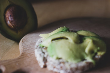 crispbread and avocado on a wooden cutting board