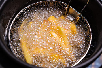 French fries. oil boiling in a deep fryer at home.