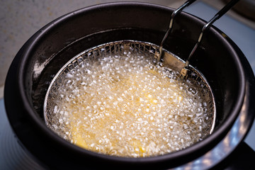 French fries. oil boiling in a deep fryer at home.
