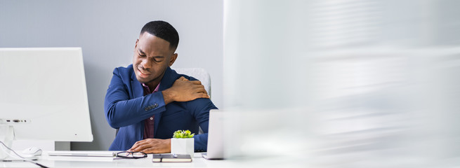 Businessman Suffering From Shoulder Pain