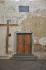 St. Anne's Church is a Roman Catholic church in Vilnius' Old Town. A big cross at the side of the wooden door.