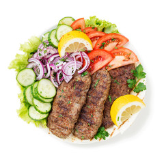 Grilled meat kebabs (cutlets) served with vegetables and tortilla, flatbread. isolated on white background