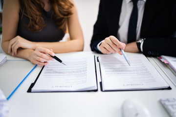 Two Businesspeople Working On Contract Paper