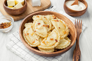 Dumplings, filled with mashed potato served with fried onion and sour cream.