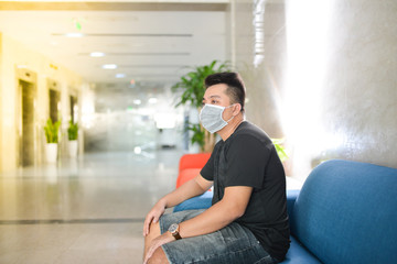 Asian man wearing medical mask at office. Wuhan China coronavirus (COVID-19) outbreak prevention. Health care and medical concept. Protection against virus, infection, exhaust.