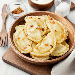 Dumplings, filled with mashed potato served with fried onion and sour cream.