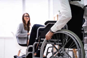 Fototapeta na wymiar Disabled Businesswoman Sitting On Wheelchair