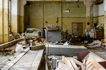 Photo of a room with the garbage of an abandoned destroyed plant. Slums, waste.