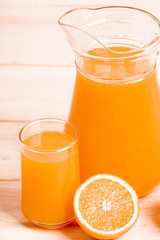 glass and jar of fresh orange juice