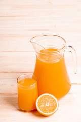 glass and jar of fresh orange juice