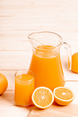 glass and jar of fresh orange juice