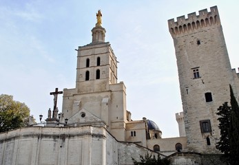 Fototapeta na wymiar Avignon Cathedral (Cathédrale Notre-Dame des Doms d'Avignon) sits next to the Palais des Papes (Palace of the Popes) in Avignon, France. Campane Tower (tour de la Campane). 