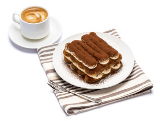 Classic tiramisu dessert on ceramic plate and cup of coffee isolated on white background with clipping path