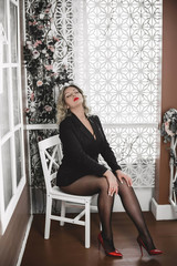Plus size model with full sexy fips in black jacket and  tights, fashionable concept 
