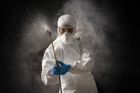 Virologist scientists wearing PPE kits are cleaning the virus