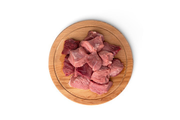 Raw sliced pork meat on wooden board isolated on white background.