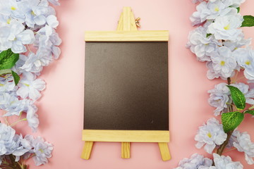 Empty Easel Space copy for text with Blooming flowers on pink background