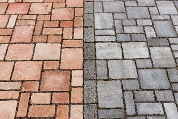 Red and gray brick paving stones on a sidewalk. Separation of bike and footpath