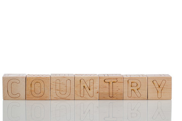 Wooden cubes with letters country on a white background