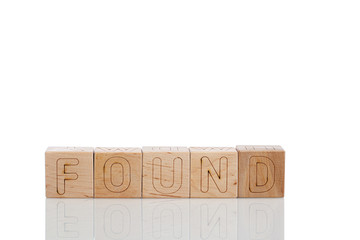 Wooden cubes with letters found on a white background