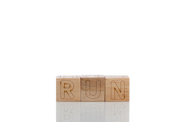 Wooden cubes with letters run on a white background