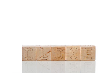 Wooden cubes with letters close on a white background