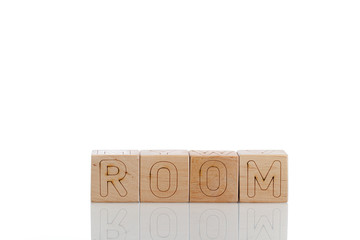 Naklejka premium Wooden cubes with letters room on a white background