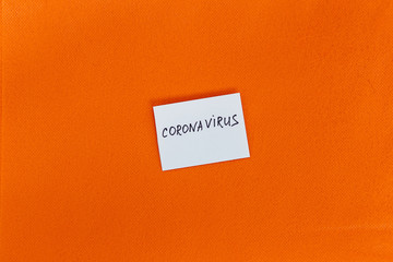 Abstract virus strain model of MERS-Cov or middle East respiratory syndrome coronavirus and Novel coronavirus 2019-nCoV with text on a background of orange spunbond.